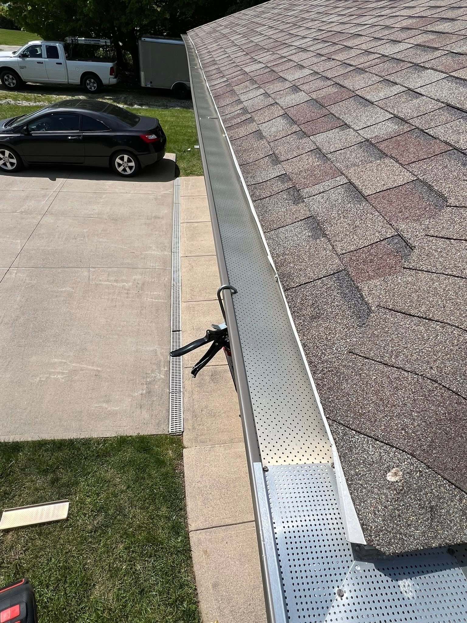 newly installed gutter guards in a shingle roof